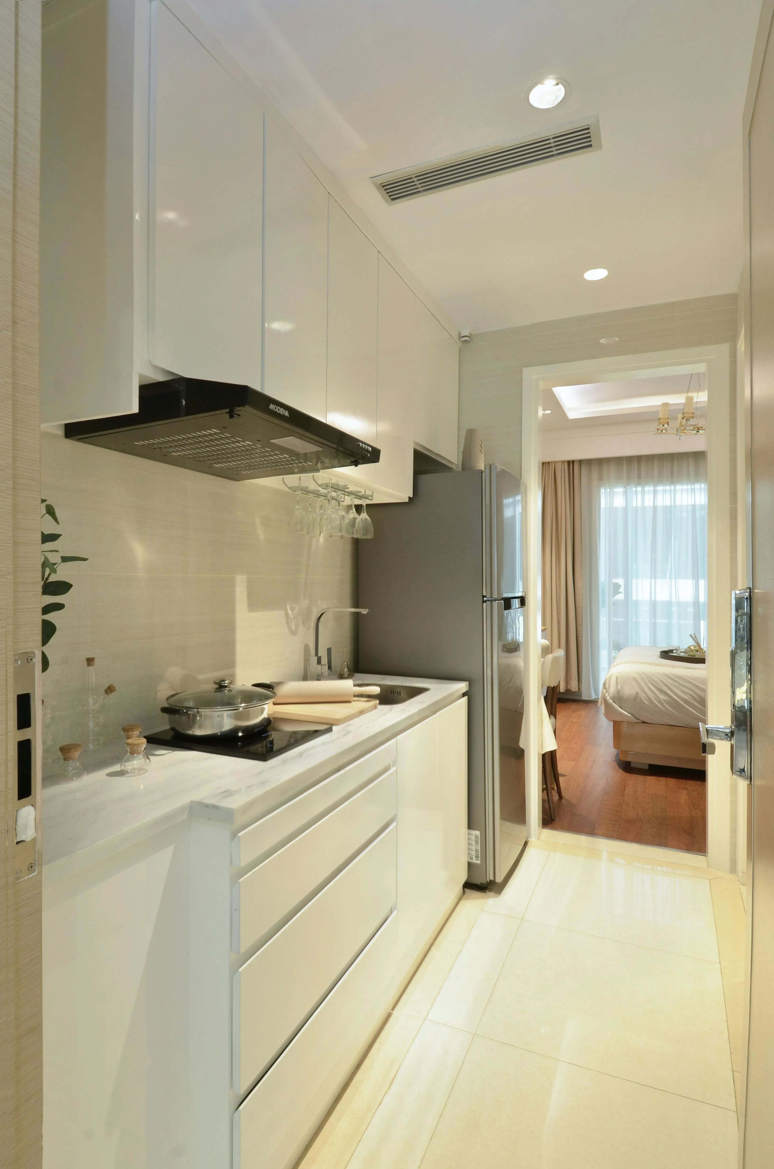 Modern kitchen opening into a bedroom