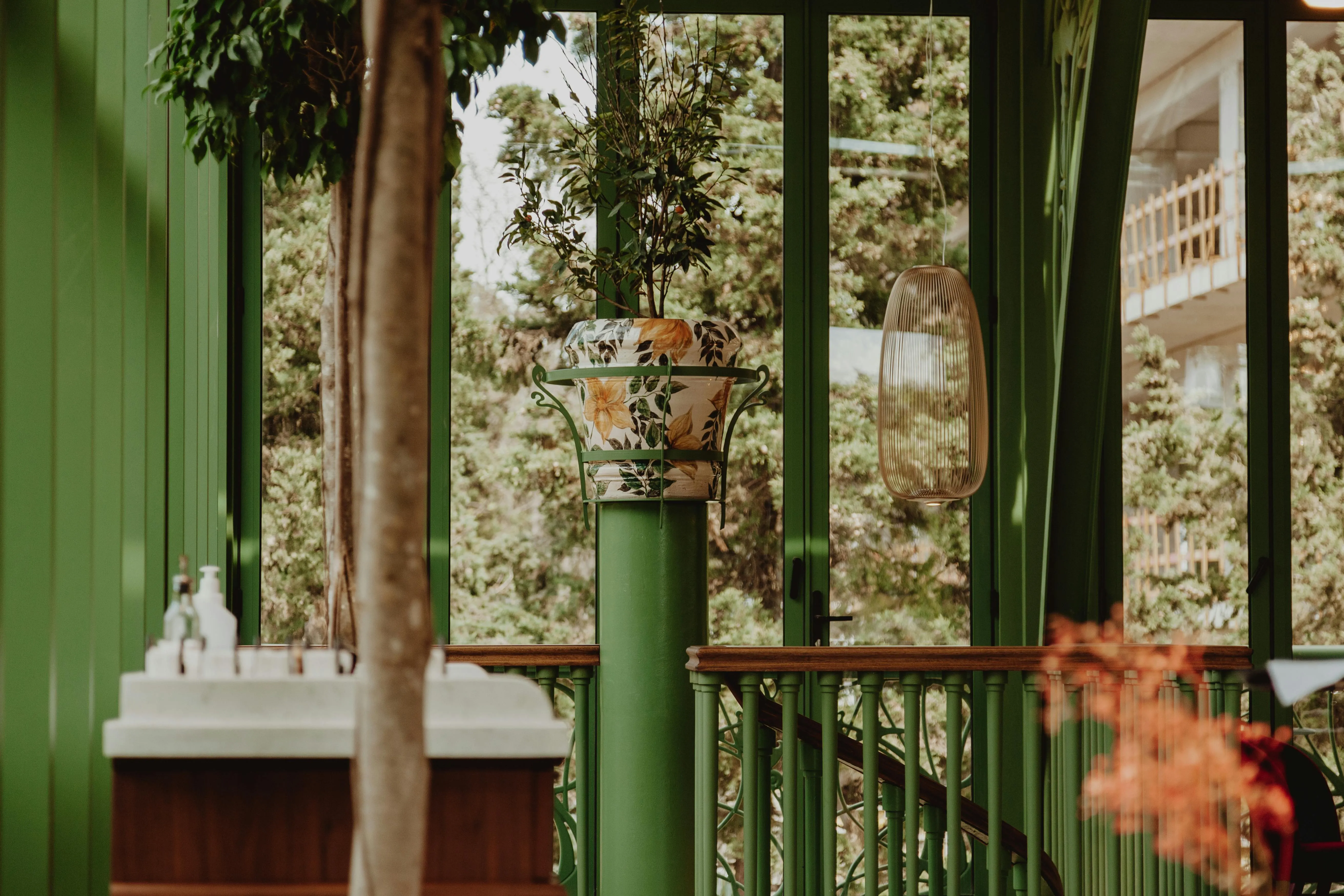 Person opening curtains to a bright room